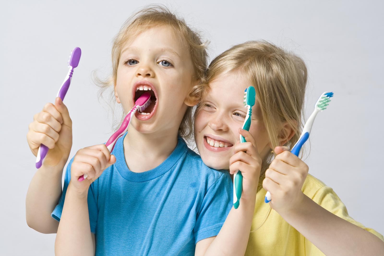 children holding toothbrushes smiling children's dentist Portage, MI