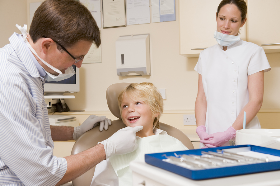 young boy seeing children's dentist, being examined Portage, MI